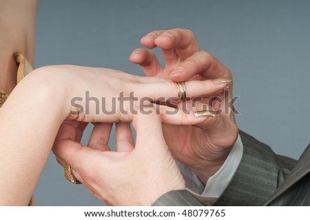 Wedding ring clothing - hands of a newly-married couple.
