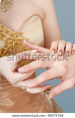 The bride dresses to the groom on a finger a gold ring.