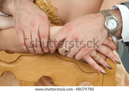 The groom has embraced the bride and holds her by the hand.