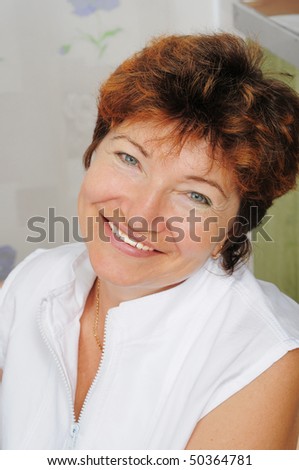 Portrait of the cheerful, elderly woman, the pensioner.