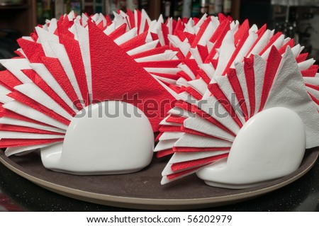 Paper napkins combined by a fan on supports. Preparation for a banquet at restaurant.