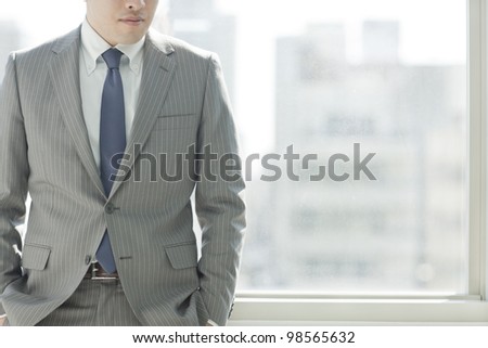 The businessman who stands by the window