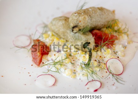 Jalapeno Poppers with fresh jalapeno, lump crab meat, beer batter and cool creamed corn salad
