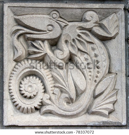 old bas-relief of fairytale fantasy crocodile on the wall