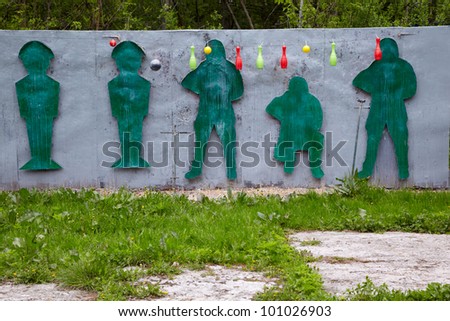 Shooting range for paintball players with figures and hanging objects