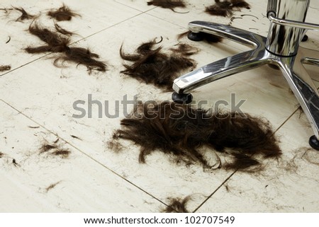 Cut hair on the floor in a hairdressing salon.