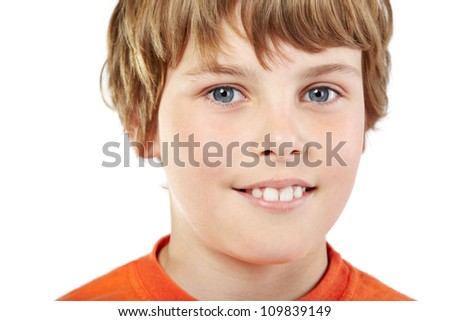 Close-up portrait of smiling boy in orange T-shirt