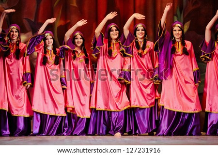 MOSCOW - JAN 28: Women dancing collective dressed in oriental dress  on stage of Red October Culture Palace during Bellydance Superiority of Moscow, Jan 28, 2012, Moscow, Russia.