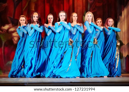 MOSCOW - JAN 28: Dancing collective in blue suits on stage of Red October Culture Palace during Bellydance Superiority of Moscow, Jan 28, 2012, Moscow, Russia.
