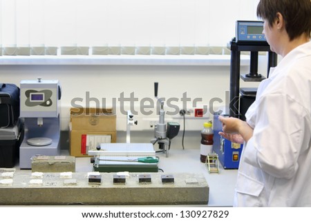 MOSCOW - JUNE 5: Woman in white clothing works in laboratory construction dry mixes on June 5, 2012 in Moscow, Russia. More than 3700 employees work in company Caparol.