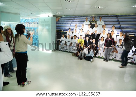 MADRID - MARCH 8: Fans are photographed near to photo Real Madrid in Santiago Bernabeu stadium on March 8, 2012 in Madrid, Spain. Real Madrid is best football club in XX century, according to FIFA.
