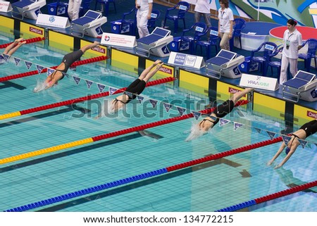 MOSCOW - APR 20: Athletes woman dive into the pool in Olympic Sports complex on Championship of Russia on swimming, on April 20, 2012 in Moscow, Russia
