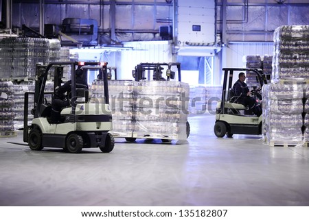 MOSCOW - MAY 31: Men work on loader machines in Ochakovo factory, on May 31, 2012 in Moscow, Russia. Moscow factory of Ochakovo company produces 750 million liters of beer annually.