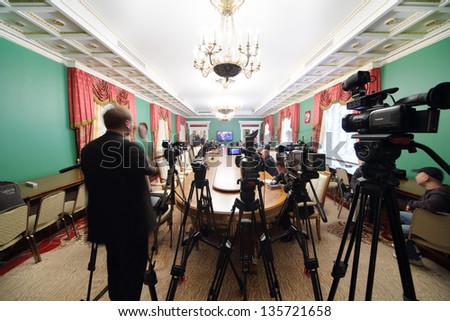 MOSCOW - APRIL 24: Video cameras and newspapermans sit in front of TV on Enlarged meeting of Council in Grand Kremlin Palace on April 24, 2012 in Moscow, Russia.
