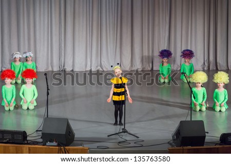 MOSCOW - APR 4: Girl in costumes of bee and girls in costumes of flowers performs on stage on District Competition Crystal droplet on April 7, 2012 in Moscow, Russia.