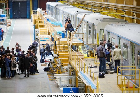 MYTISHCHI - APR 18: Excursionists and press in shop floor at  Mytishchi Metrovagonmash factory, April 18, 2012, Mytishchi, Russia. The plant is famous for creating user-friendly subway cars.