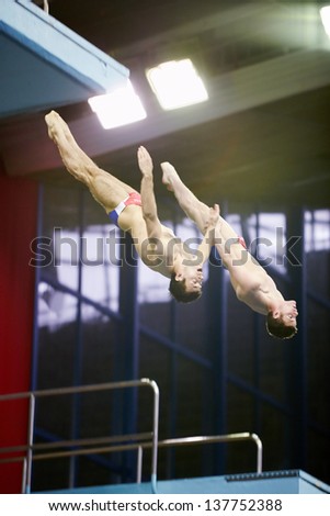 MOSCOW - APR 13: Athletes jump from tower at competitions on syncronized springboard diving in Pool of SC Olympic on day of third phase of World Series of FINA Diving, April 13, 2012, Moscow, Russia.