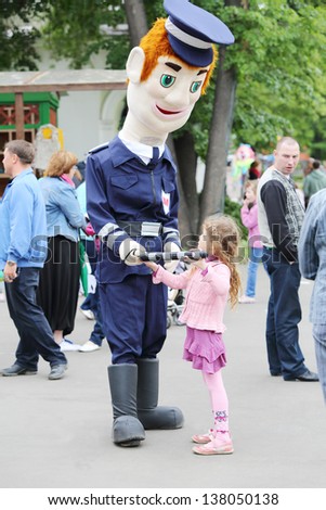 MOSCOW - JUNE 1: Girl with large puppet Militiaman at III Moscow Festival of puppets and game programs Long live game! in Hermitage Garden on Petrovka Street, on June 1, 2012 in Moscow, Russia.