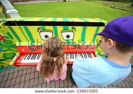 MOSCOW - JUNE 1: Children play piano at III Moscow Festival of puppets and game programs Long live game! in Hermitage Garden on Petrovka Street, on June 1, 2012 in Moscow, Russia.