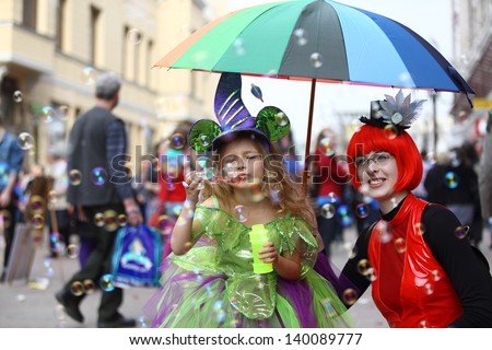 MOSCOW - APRIL 22: Adults and children in fancy dress having fun on the holiday of spring and bubbles, Dreamflash, on Apr 22, 2012 in Moscow, Russia