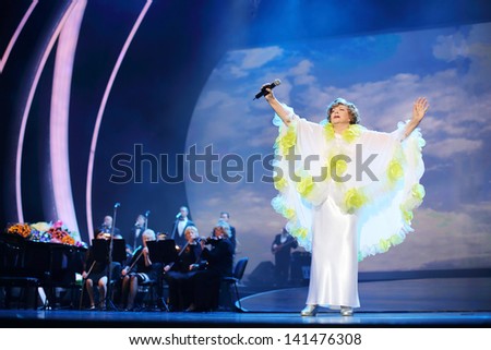 MOSCOW - OCTOBER 14: Edyta Piecha in white rises hands at her anniversary concert in Kremlin Palace, on October 14, 2012 in Moscow, Russia. Famous Russian singer Edita Piecha sings on stage 55 years.
