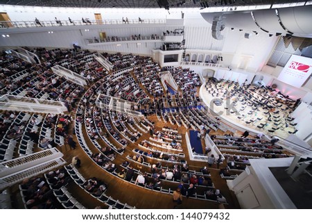 MOSCOW - SEPTEMBER 8: Side view of people sit down on seats prior to IV Grand Festival of Russian National Orchestra in Tchaikovsky Concert Hall, on September 8, 2012 in Moscow, Russia.