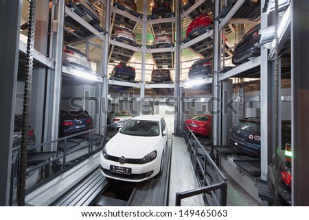 MOSCOW - JAN 11: The Volkswagen Golf on lift in premises for storage cars in Volkswagen Center Varshavka at night on January 11, 2013, Moscow, Russia. The tower was designed and built in 2009