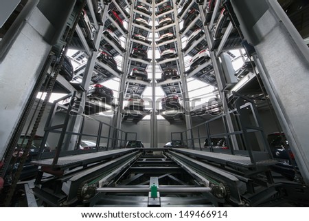 MOSCOW - JAN 11: A mechanism for lifting vehicles in the tower for storage and presentation cars in Varshavka Center on January 11, 2013, Moscow, Russia. The tower was designed and built in 2009