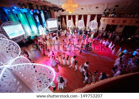 MOSCOW - JAN 5: Children dance in circle in Golden Room of Surikov Hall during White Ball - holiday for children on winter school vacation, January 5, 2013, Moscow, Russia.