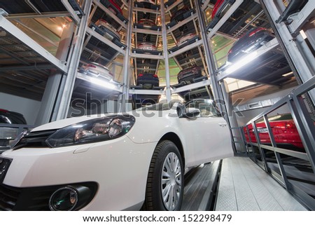 MOSCOW - JAN 11: The car with open door against the background of the other cars in tower for store cars in Volkswagen Center Varshavka at night on January 11, 2013, Moscow, Russia