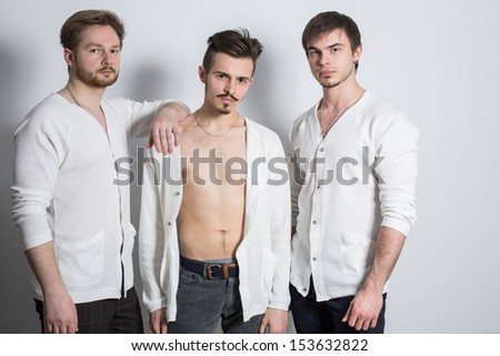 Three men in a white cardigan over his naked body in the studio