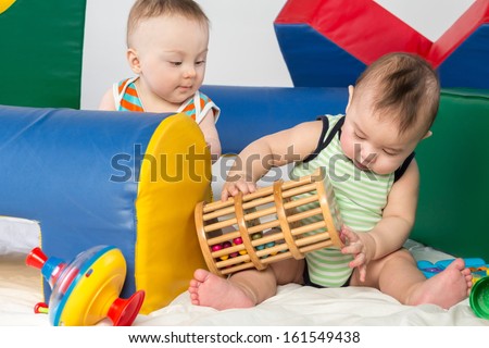 Two toddlers with toys in the gaming complex