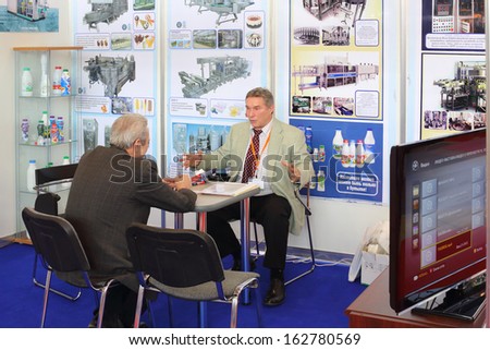 MOSCOW - MAR 12: Two people talking at the 12th International Exhibition Dairy and Meat Industry on March 12, 2013 in Moscow, Russia.