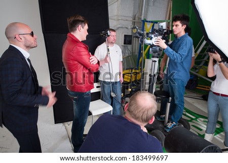 RUSSIA, MOSCOW - DEC 22, 2013: People working during shooting video clip of the musical group Hello with many feathers in Double Mint Studio.