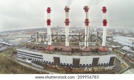 The territory of the plant with four pipes in the city, aerial view