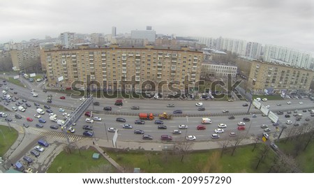Cityscape with wide road and many residential buildings, aerial view