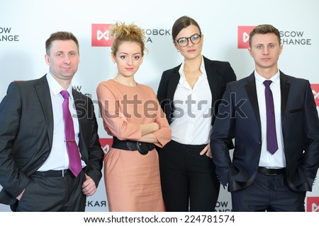 MOSCOW, RUSSIA - APR 10, 2014: Business group: two men and two women standing in line in office Moscow Exchange
