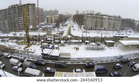 MOSCOW, RUSSIA - MAR 19, 2014: City traffic near building site of interchange on Shelkovskoe highway at winter day. Aerial view