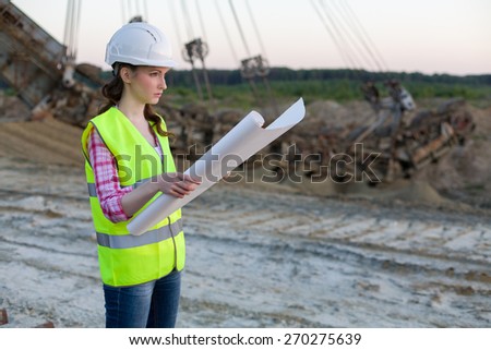 female worker examines drawing on a background of career Stacker