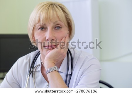MOSCOW - JUNE 27, 2014: Woman physician props chin in Scientific-practical center of medical care for children with developmental disabilities, craniofacial and congenital diseases of nervous system