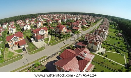 Aerial view of many similar houses in cottage settlement at sunny summer day.