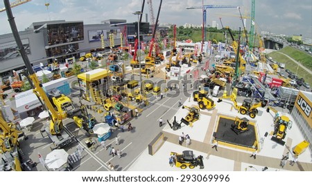 RUSSIA, MOSCOW - JUN 6, 2014:  People walk by International Specialized Exhibition of Construction Equipment and Technologies CET 2014 at Crocus Expo. Photo with noise from action camera