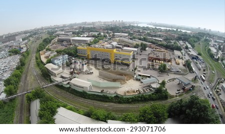 RUSSIA, MOSCOW - JUN 7, 2014: Aerial view of cityscape and cement - concrete factory, Mechanization-2. Photo with noise from action camera