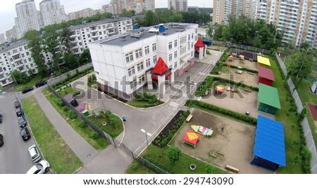 RUSSIA, MOSCOW - 28 MAY, 2014: Kindergarten with playgrounds near dwelling houses and car parking at spring day. Aerial view