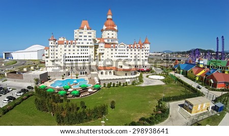 RUSSIA, SOCHI - JUL 29, 2014: Bogatyr hotel complex near amusement park at summer sunny day. Aerial view. Photo with noise from action camera.