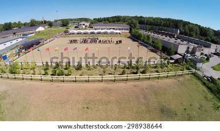 RUSSIA, MOSCOW - JUL 13, 2014: Horsemen formation on arena of equestrian complex Sozidatel during Russian Championship for Dzhigitovka at summer day. Aerial view. Photo with noise from action camera.