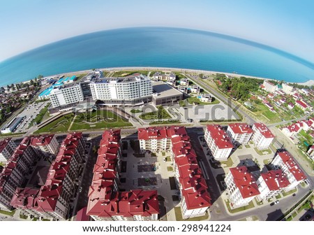 RUSSIA, SOCHI - JUL 30, 2014: Town-hotel Barhatnye Sezony and hotel Radisson Blu on sea shore. Aerial view. Photo with noise from action camera.