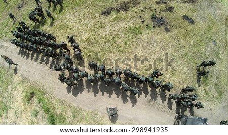 RUSSIA, NELIDOVO - JUL 12, 2014: Soldiers in uniform of german and soviet armies on field during reconstruction Battlefield at summer sunny day. Aerial view. Photo with noise from action camera