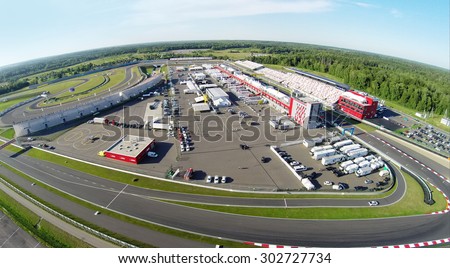 RUSSIA, MOSCOW - JUL 12, 2014: Trucks and cars parked on stadium Moscow Raceway. Aerial view (Photo with noise from action camera)