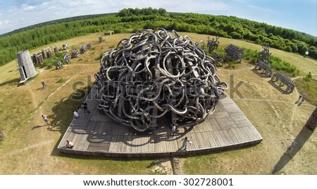 RUSSIA, NICOLA-LENIVETS - JUL 5, 2014: People near art object Universal Mind in Wonderland Park during 9 International Festival of landscape objects Archstoyanie. (Photo with noise from action camera)